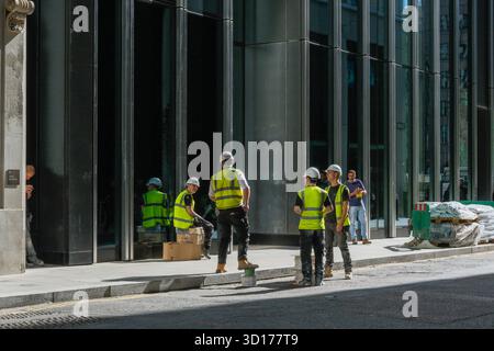 Construction workers taking a break, City of London, UK Stock Photo
