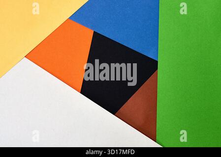 Brightly colored sheets of paper in various shades are laid out in a geometric pattern on a flat surface. Stock Photo