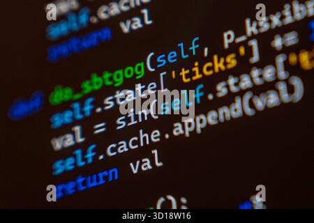 A detailed view of programming code displayed on a computer screen, showcasing syntax highlighting in various colors. Stock Photo
