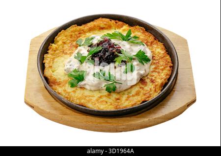 a large potato pancake in a frying pan Stock Photo