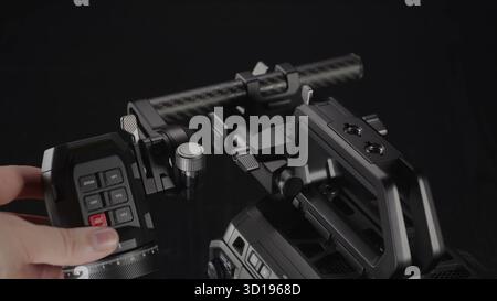 A hand activates the recording function on a professional cinema. Stock Photo