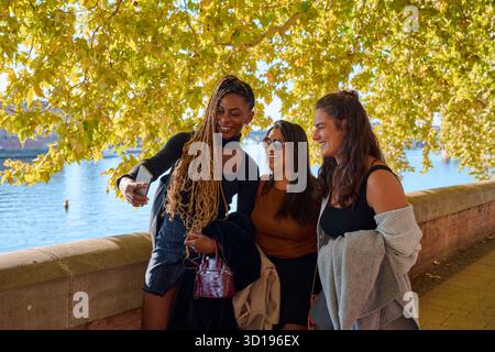Three happy women friends taking selfie in toulouse Stock Photo