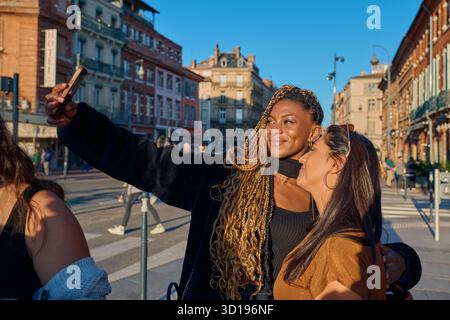 Women friends taking selfie in toulouse city street Stock Photo