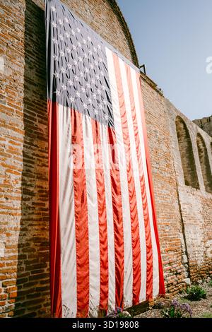 Close up of American flag hung on brick wall Stock Photo