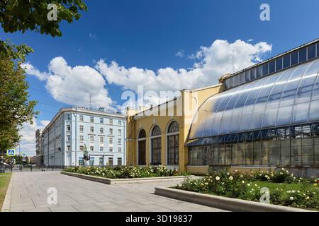 Sunlit greenhouse and architecture on a clear day in the city Stock Photo