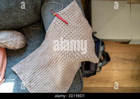 Overhead View of Crochet Blanket in Progress on Arm of Chair Stock Photo