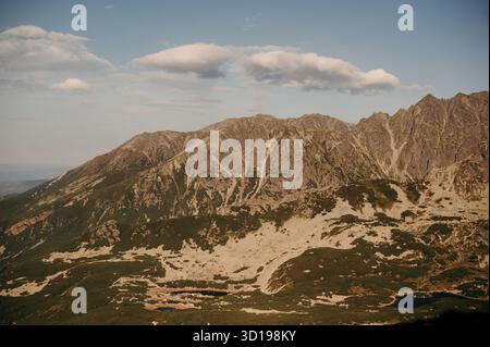 Rugged Mountain Peaks Under Clear Sky Stock Photo
