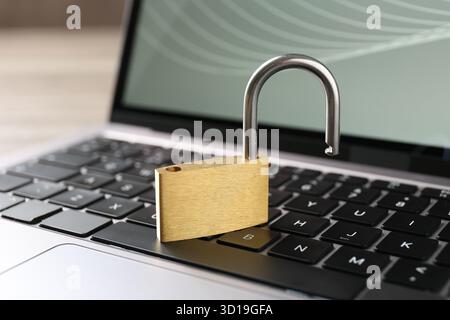 Password concept. Open padlock and laptop on table, closeup Stock Photo