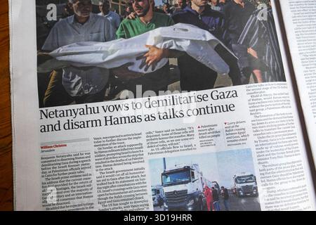 Benjamin 'Netanyahu vows to demilitarise Gaza and disarm Hamas as talks continue' Guardian newspaper headline Israel war article 21 October 2025 UK Stock Photo