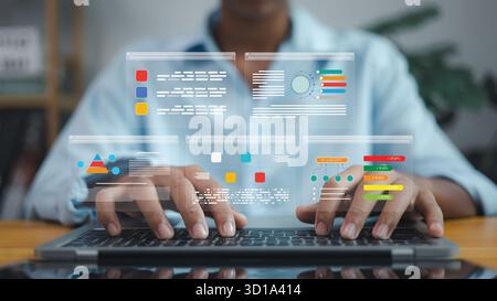 Businessman using laptop with virtual data analytics dashboard and futuristic interface for digital technology, data analysis, and business intelligen Stock Photo