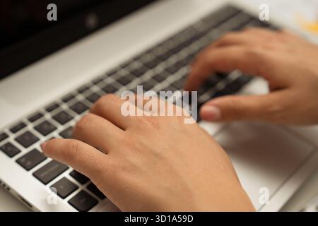 Person typing on a laptop keyboard, representing work, education, and technology concepts Stock Photo