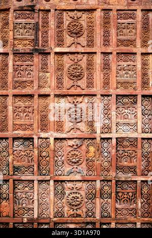Ornate Carved Red Stone Wall Panels With Geometric Floral Patterns and Repeating Motifs Stock Photo