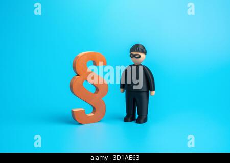 A thief, a con man, and a symbol of the law. Legislation and loopholes. Crime and punishment. Fraud and justice confrontation. Financial crime article Stock Photo