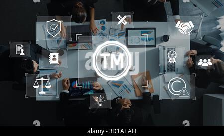 A dynamic business meeting featuring diverse professionals engaged in discussions about trademark and intellectual property strategies while analyzing Stock Photo