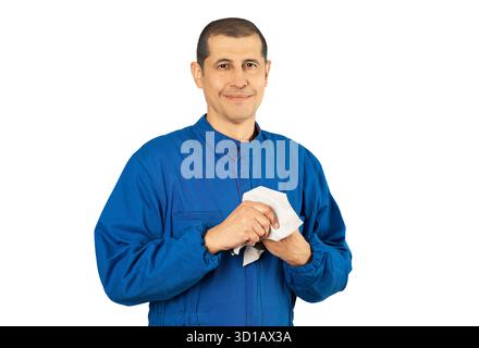 Technician working in car shop wipes hands with rag with white background. Stock Photo