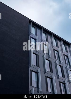 Close-up view of modern facade with repeating windows and minimalist geometric structure. Stock Photo
