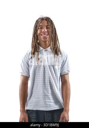 Young black man with dreadlocks standing and smiling at camera Stock Photo