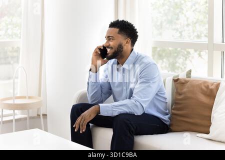 African man holds smartphone, lead pleasant, personal conversation Stock Photo