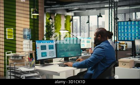 Female colleague bringing documents folders for general manager, assisting the team leader with stack of archived files. Secretary ensuring efficient organizational workflow. Stock Photo