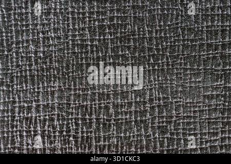 The surface displays a detailed, textured design with a dark color scheme. The patterns create a visually engaging appearance, emphasizing depth and c Stock Photo