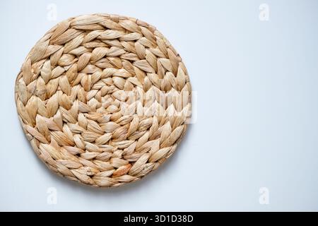 A round woven placemat made from natural water hyacinth isolated on white background Stock Photo