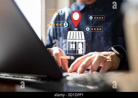 Digital marketing concept showing hands using laptop to manage online local business reputation and customer feedback reviews with rating stars and lo Stock Photo