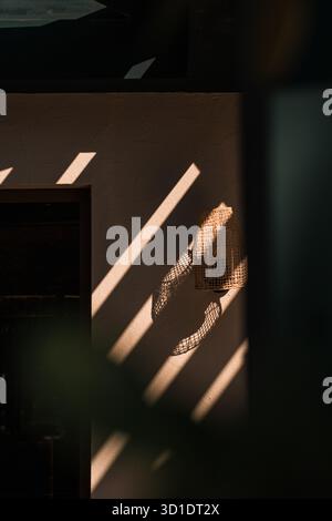 Abstract light and shadow pattern on a wall.  Strong diagonal sunlight creates graphic lines and contrast. Minimalist architectural detail. Stock Photo