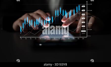 Close-up view of hands interacting with a tablet displaying financial graphs and charts, highlighting business growth, investment opportunities, and m Stock Photo