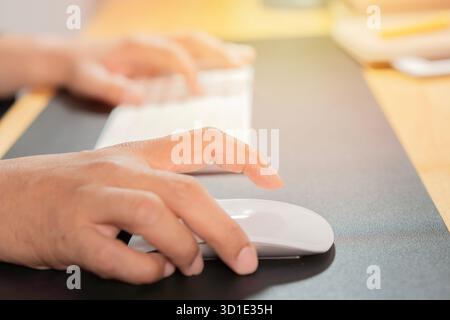 Man working with desktop computer in office closeup of hand clicking mouse. Online market research concept. Stock Photo