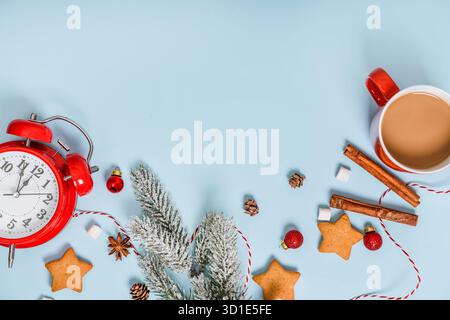 Christmas and New Year holiday composition. Flat lay with blank copy space. An alarm clock with decorations on an isolated background. Top view festiv Stock Photo
