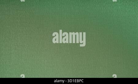 Green textured background creating a subtle gradient effect, ideal for design projects requiring a textured and colorful backdrop Stock Photo