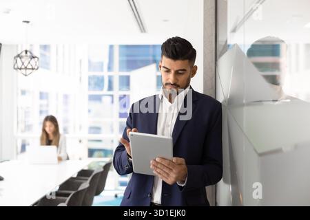 Focused busy Indian manager man using business application Stock Photo