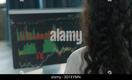 Back view business woman looking in computer with data analytics graphic female reviewing financial result businesswoman working analyzing marketing Stock Photo