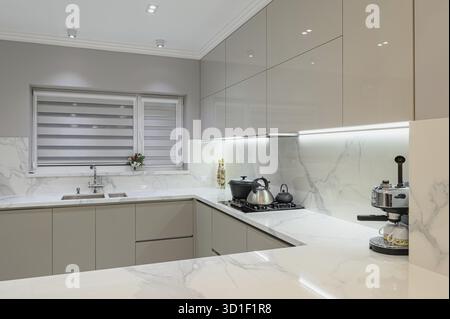 Luxury large modern white marble kitchen united with dining room Stock Photo