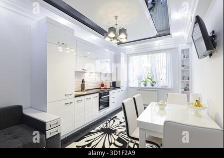 Luxury modern black and white kitchen with carpet on floor Stock Photo