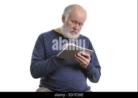 Funny bald and bearded old man using tablet computer, isolated on white Stock Photo