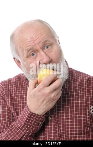 Handsome bald and bearded senior man eating the apple, isolated on white background Stock Photo