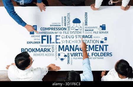 A professional team collaborates over a table, engaging in discussions about cloud storage management concepts, focusing on file metadata and document Stock Photo