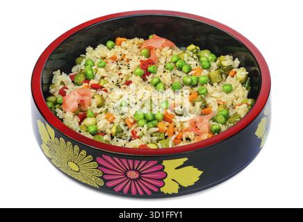 Risotto with rice, green peas, carrot, bell pepper, pickled cucumbers in black bowl isolated on white background Stock Photo