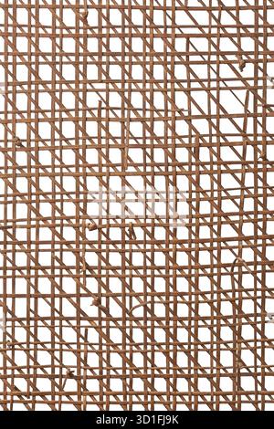 close-up of woven wicker or rattan texture, chaotic mesh of brittle reddish-brown strands isolated white background, aged wear and natural materials Stock Photo