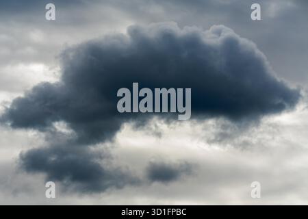 Cumulus clouds are low-level clouds that appear as dense, puffy formations with clearly defined edges. Stock Photo