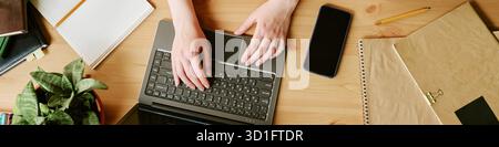 Header of Hands of Woman Working on Laptop Stock Photo