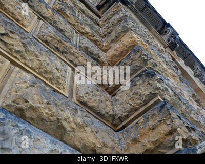 Historic rusticated stone wall with irregular, rough blocks. Close-up. Copyspace. Stock Photo