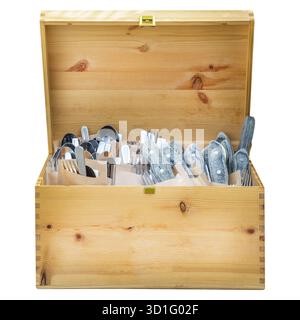 Isolated wooden box with spoons, knives and forks on a white background Stock Photo