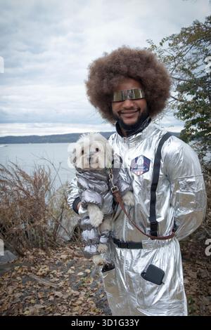 A man from outer space & his cute Maltese Yorkie mix at the 2025 Halloween Dog Parade in Croton On Hudson, Westchester, New York Stock Photo