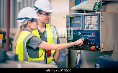 Engineers team mechanic using computer controller Robotic arm for welding steel in steel factory workshop. Industry robot programming software for aut Stock Photo