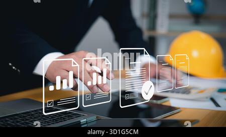 Businessman using laptop with virtual data files and workflow icons. Concept of digital document management, automation, data approval, and paperless Stock Photo