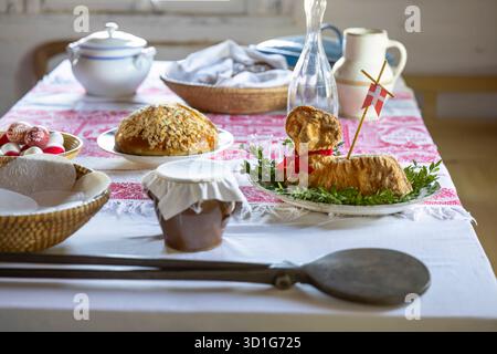 Traditional baked lamb cake with a red ribbon and a flag on a festive Easter table Stock Photo