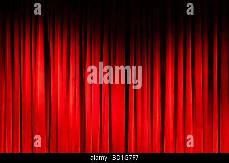 Deep red velvet curtain creating a performance stage background Stock Photo