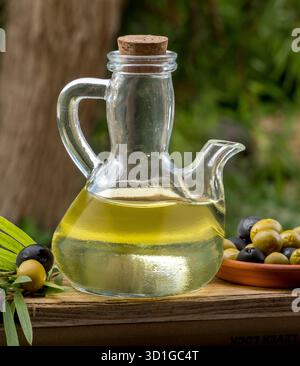 Glass oiler with olive oil and olives Stock Photo